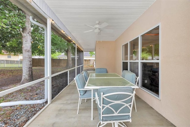 sunroom featuring outdoor dining area and ceiling fan