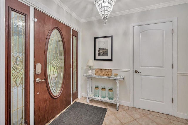 foyer entrance with crown molding, light tile patterned floors, and a chandelier