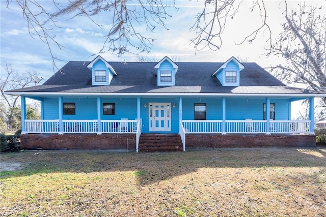 view of front of house with a porch and a front yard