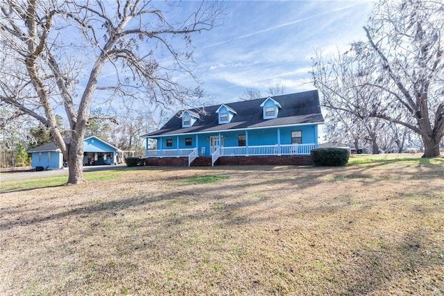 cape cod house with covered porch and a front yard