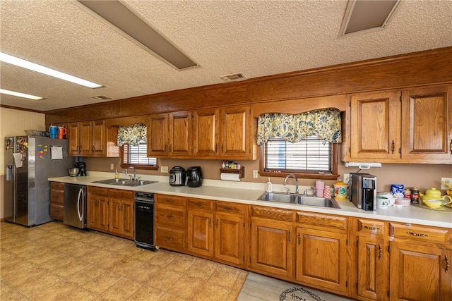 kitchen featuring stainless steel appliances, sink, and a wealth of natural light