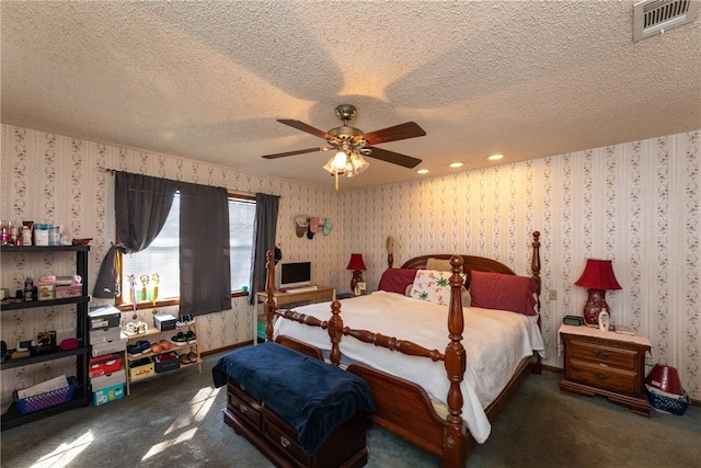 bedroom featuring ceiling fan and a textured ceiling