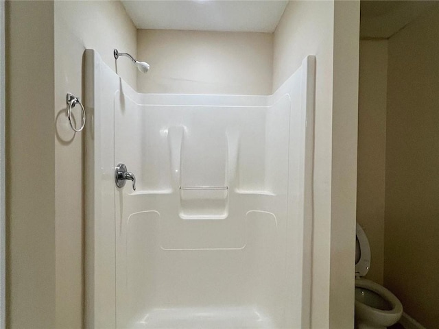 bathroom featuring toilet and a shower