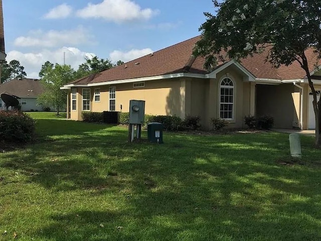 back of house with a lawn