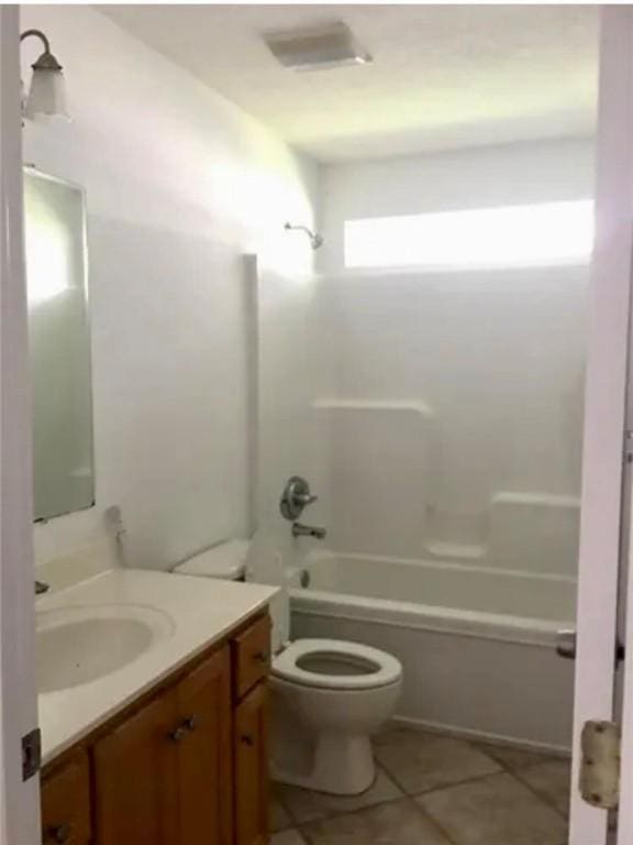 full bathroom featuring tile patterned floors, shower / washtub combination, vanity, and toilet