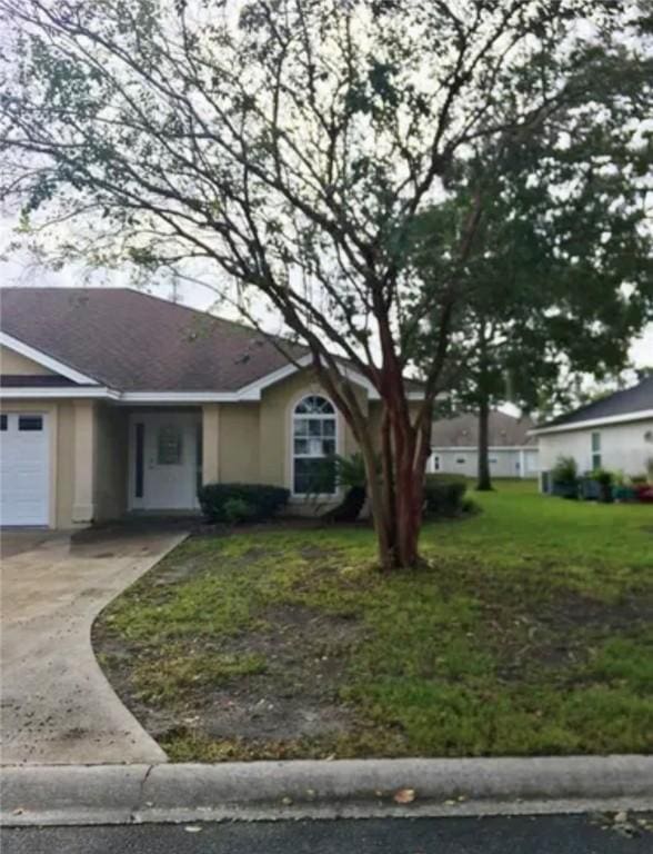 ranch-style house with a front yard and a garage