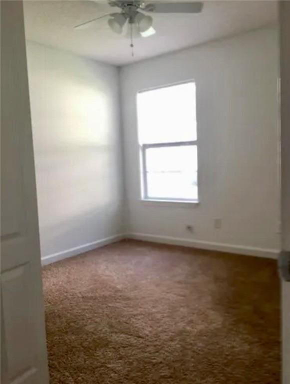 empty room with carpet and ceiling fan