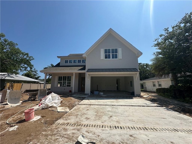 638 Dellwood Ave, Saint Simons Island, GA 31522 - view of front facade featuring a standing seam roof, concrete driveway, a garage, and a metal roof