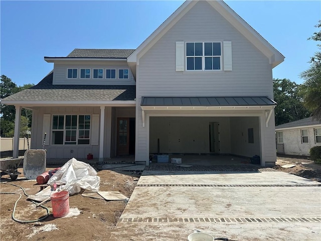 638 Dellwood Ave, Saint Simons Island, GA 31522 - view of front facade featuring a shingled roof, driveway, a porch, a standing seam roof, and a metal roof