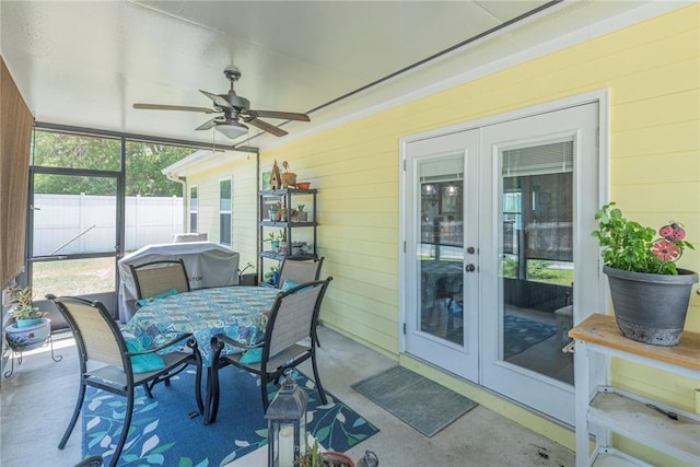 sunroom / solarium featuring a ceiling fan and french doors