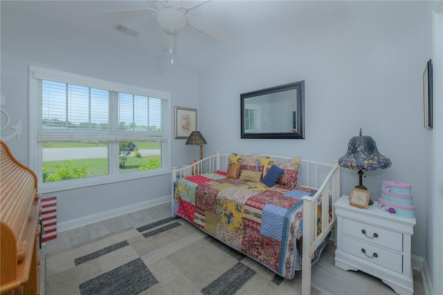 bedroom featuring ceiling fan, visible vents, and baseboards