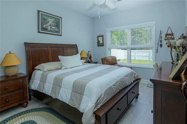 bedroom featuring light wood-style floors, ceiling fan, and baseboards