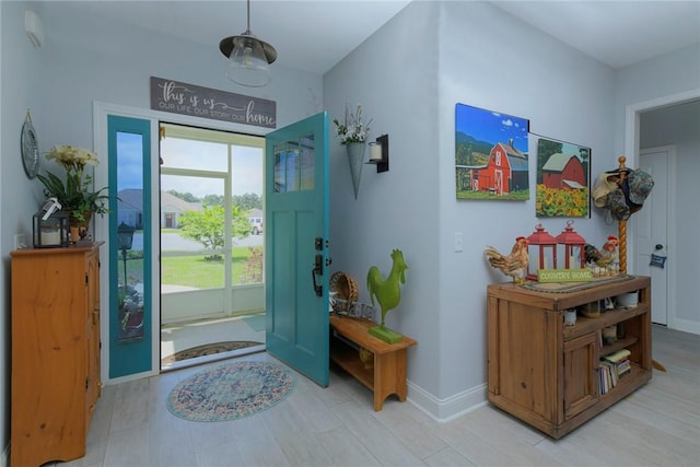 foyer featuring baseboards