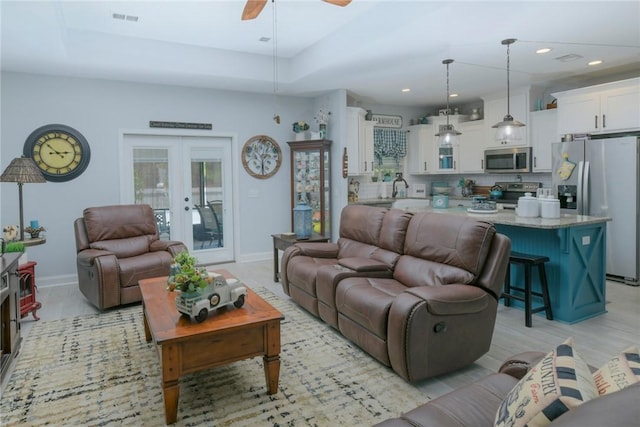 living room with recessed lighting, french doors, visible vents, and baseboards