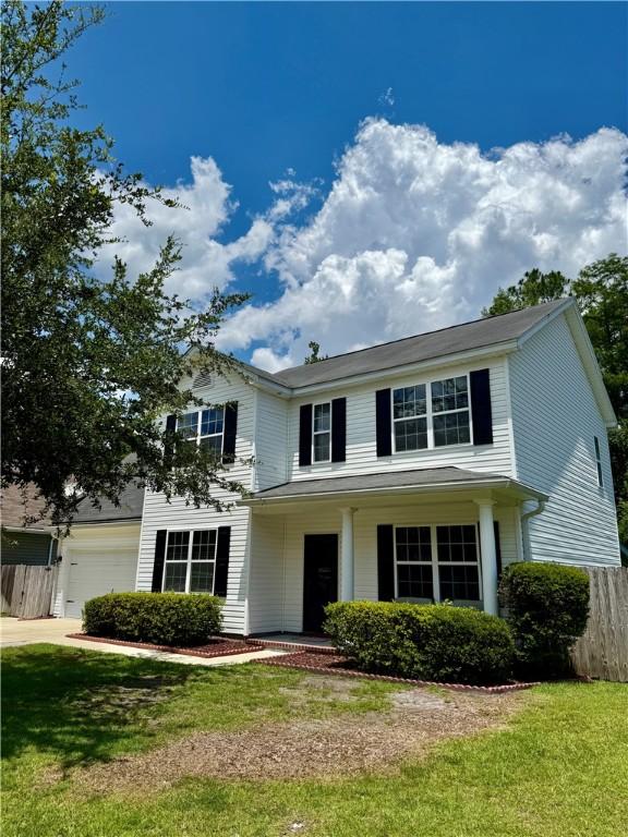 111 Covington Pointe Dr, Brunswick, GA 31523 - traditional-style house featuring an attached garage, driveway, and covered porch