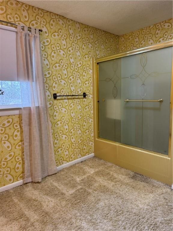 bathroom with bathing tub / shower combination and a textured ceiling