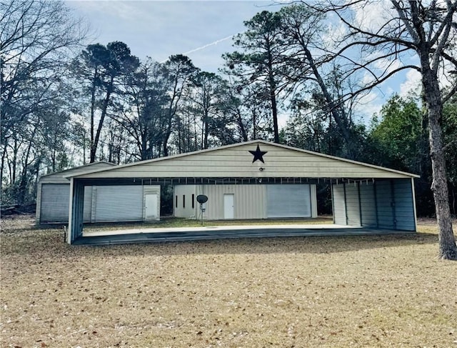 exterior space featuring a garage and an outbuilding