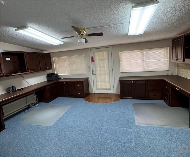 office with ceiling fan, built in desk, and a textured ceiling