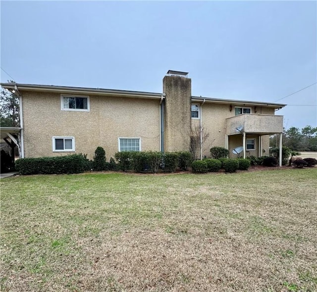 exterior space featuring a yard and a balcony