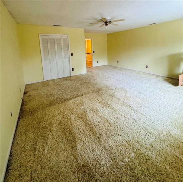 unfurnished bedroom with carpet floors, a closet, and a textured ceiling