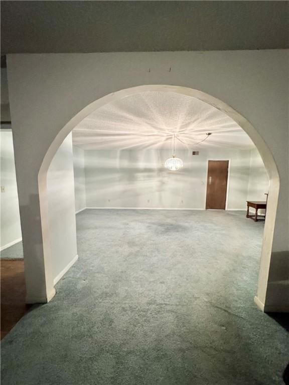 spare room with carpet floors and a textured ceiling