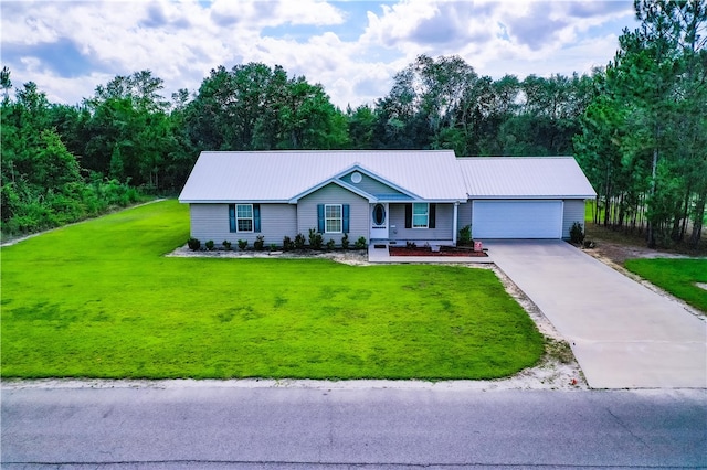 4718 Otter Creek Cir, Blackshear, GA 31516 - ranch-style house featuring driveway, a garage, a front yard, and a metal roof