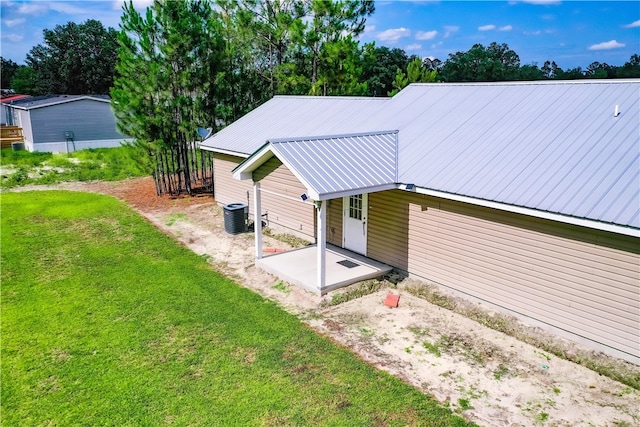 4718 Otter Creek Cir, Blackshear, GA 31516 - rear view of property featuring a patio, a lawn, and a metal roof
