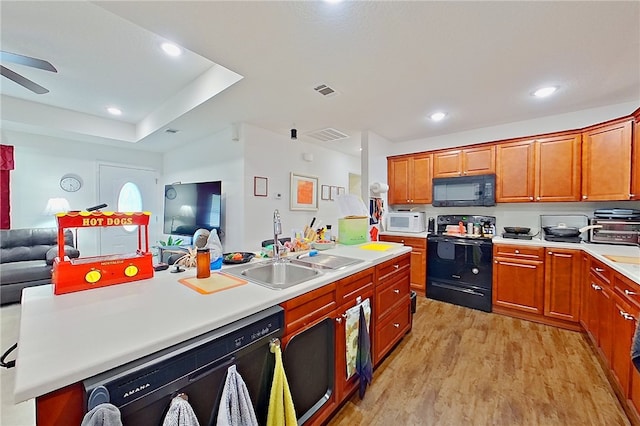 4718 Otter Creek Cir, Blackshear, GA 31516 - kitchen featuring black appliances, open floor plan, light wood finished floors, a ceiling fan, and light countertops