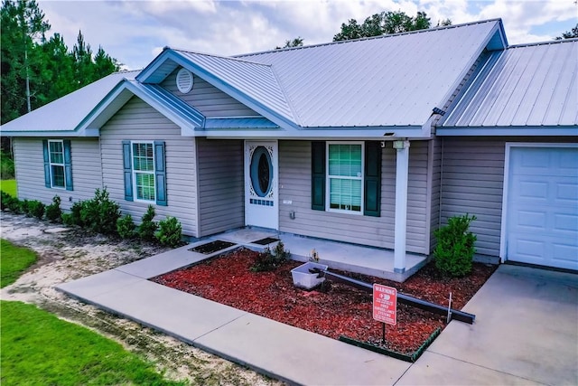 4718 Otter Creek Cir, Blackshear, GA 31516 - single story home with covered porch, a metal roof, and a garage