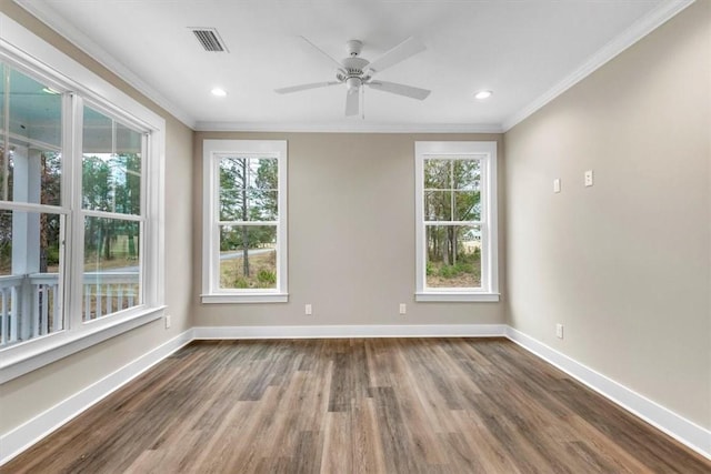 spare room featuring crown molding, dark wood-type flooring, and ceiling fan