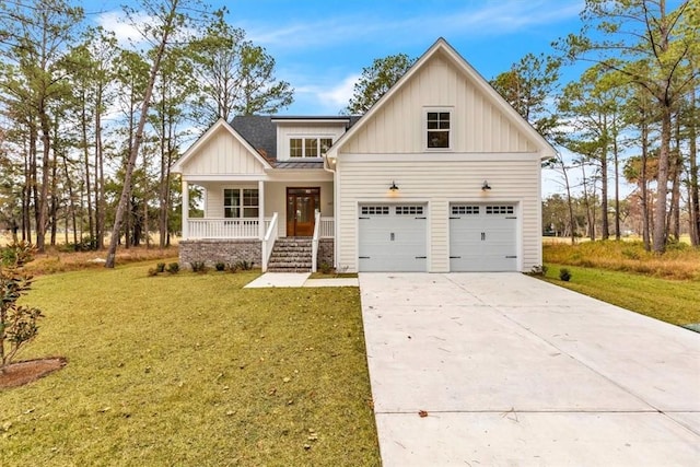 view of front of property with a porch, a garage, and a front lawn