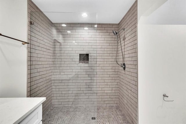 bathroom featuring vanity and tiled shower