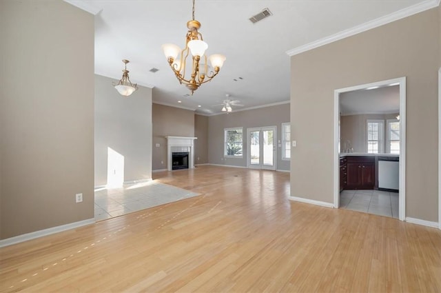 unfurnished living room featuring ceiling fan with notable chandelier, crown molding, and light hardwood / wood-style floors