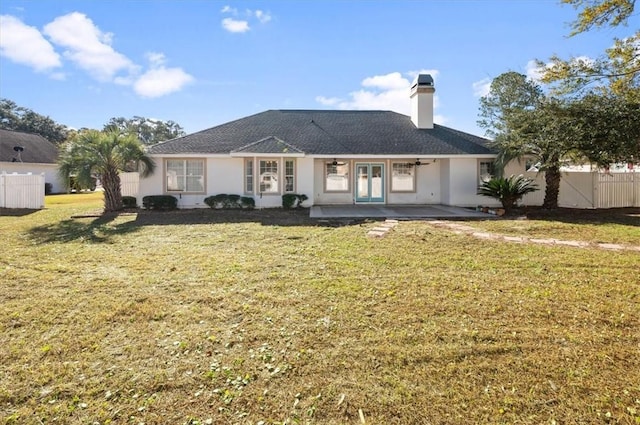 rear view of property featuring a yard