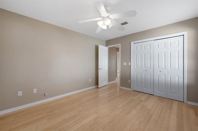 unfurnished bedroom featuring ceiling fan, a closet, and light hardwood / wood-style flooring