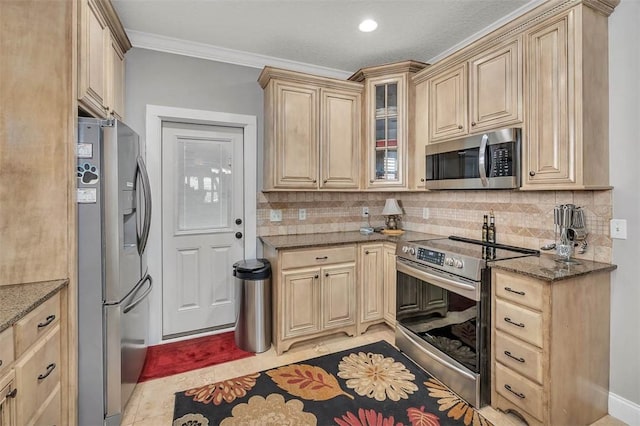 kitchen with appliances with stainless steel finishes, backsplash, ornamental molding, and dark stone countertops