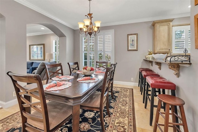 dining room with ornamental molding, a notable chandelier, and light tile patterned flooring