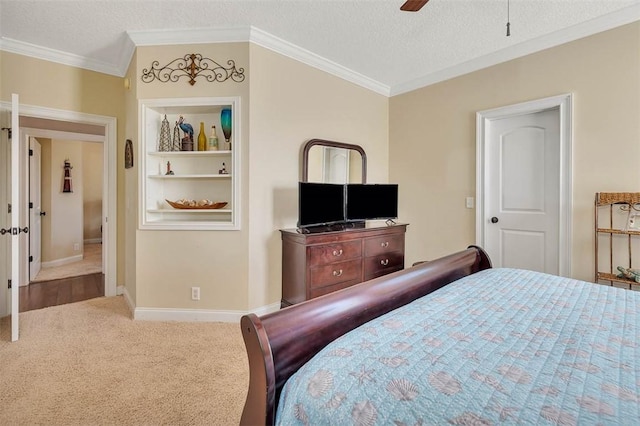 bedroom featuring ceiling fan, carpet, a textured ceiling, and ornamental molding