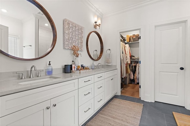 bathroom featuring double vanity, crown molding, a sink, and tile patterned floors