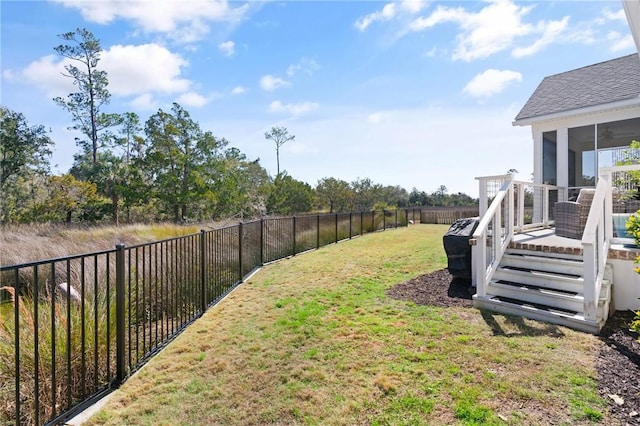 view of yard featuring a sunroom, a fenced backyard, and a deck