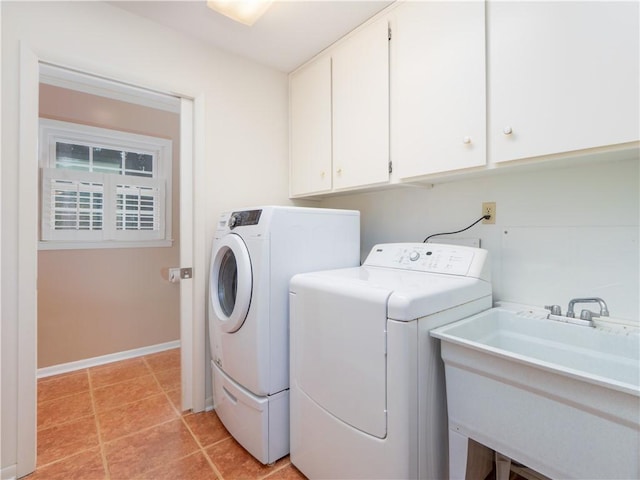 washroom with cabinets, separate washer and dryer, sink, and light tile patterned floors