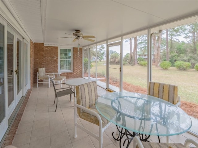 sunroom / solarium featuring ceiling fan