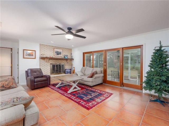 tiled living room with a fireplace, ceiling fan, crown molding, and french doors