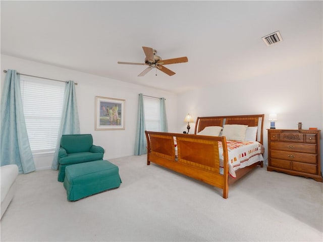 bedroom featuring light colored carpet and ceiling fan