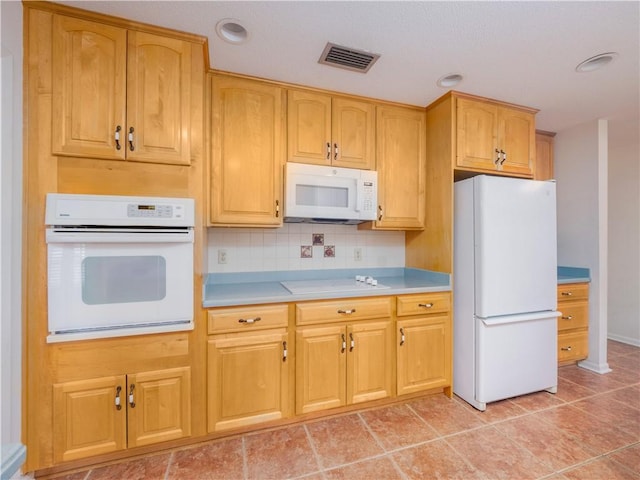 kitchen with backsplash and white appliances