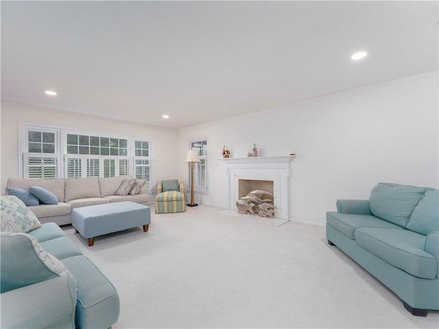 carpeted living room with ornamental molding