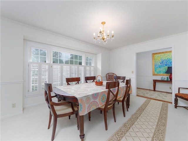 dining space with ornamental molding and an inviting chandelier