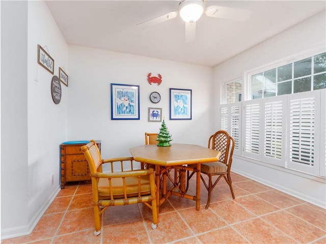 tiled dining area with ceiling fan and plenty of natural light