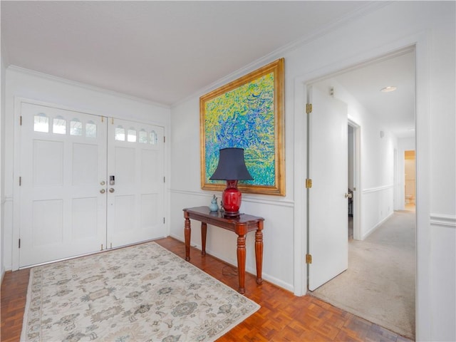 foyer featuring parquet floors and crown molding