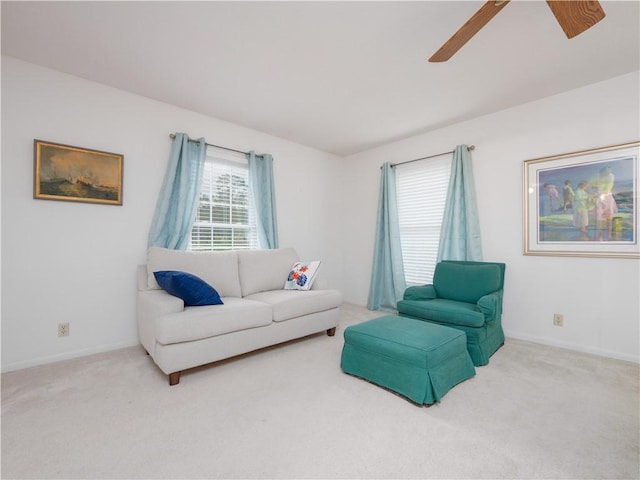 carpeted living room featuring ceiling fan